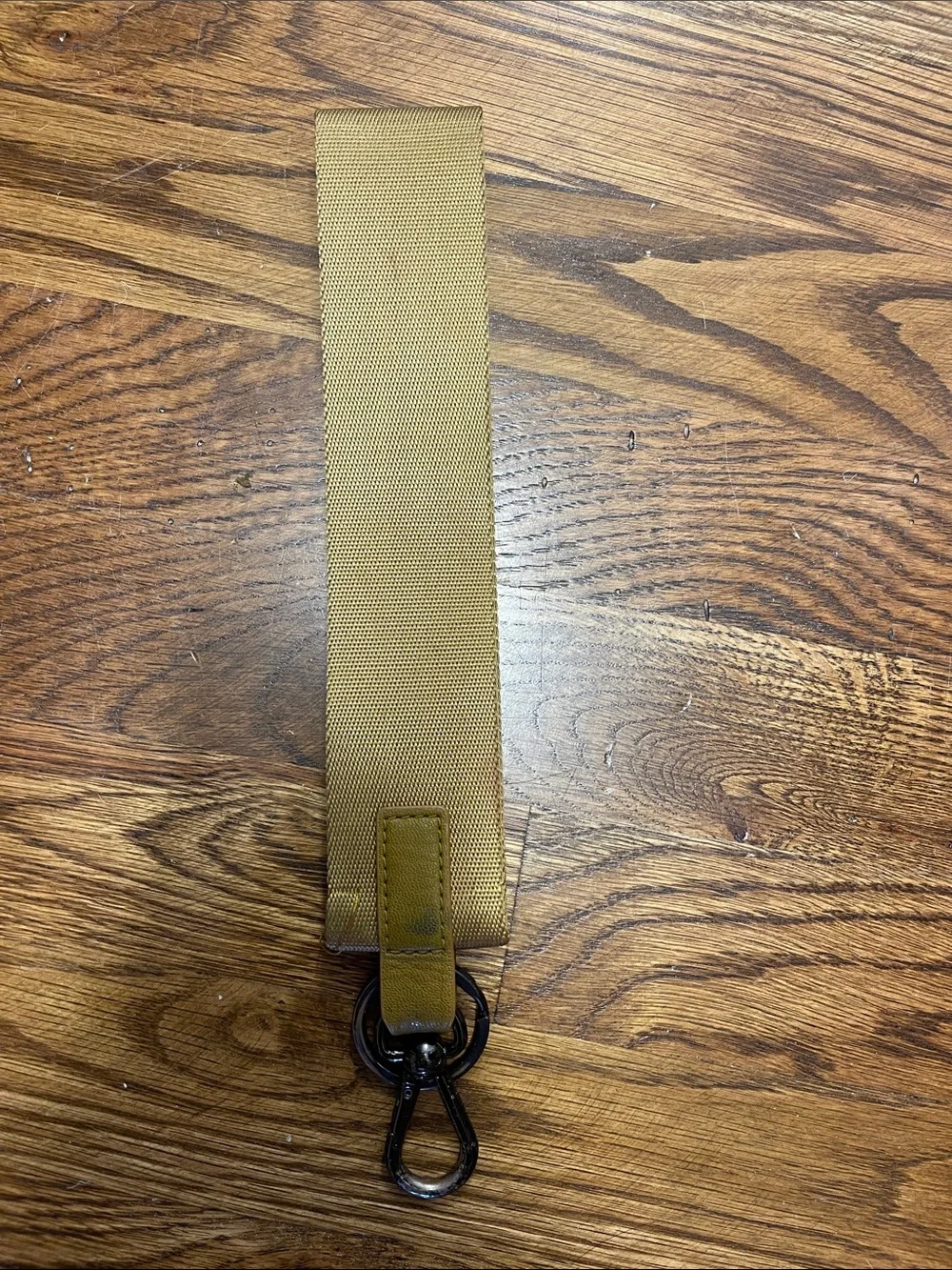 Lululemon tan wristlet key fob with orange logo